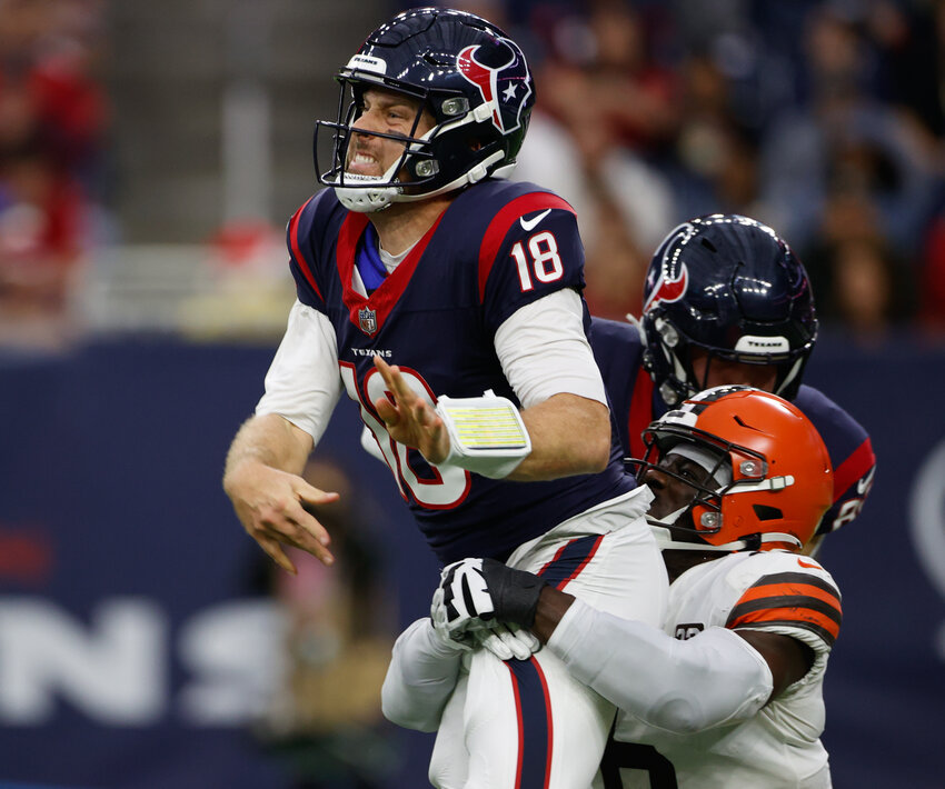 Texans quarterback Case Keenum (18) is hit by Browns linebacker Jeremiah Owusu-Koramoah (6) on a pass during an NFL game between the Houston Texans and the Cleveland Browns on December 24, 2023 in Houston.