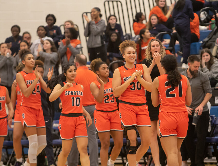 Seven Lakes players celebrate during a timeout during Friday's game between Seven Lakes and Taylor at the Taylor gym.
