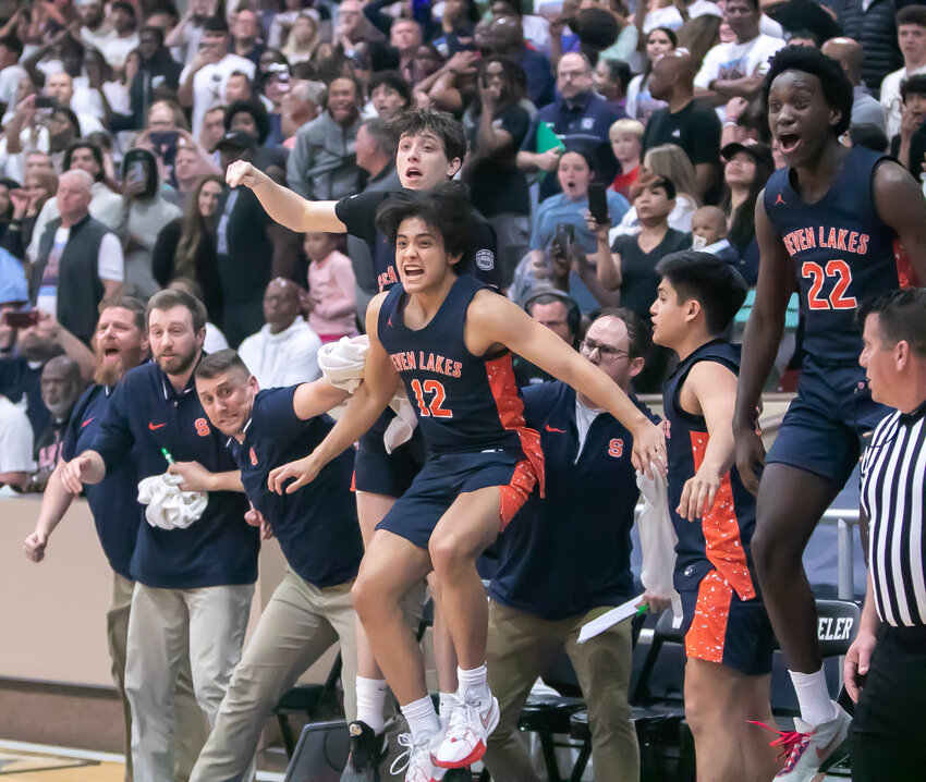 The Seven Lakes bench celebrates after Christian Hollis hit a 3-pointer during a game between Seven Lakes and Clements at Wheeler Fieldhouse.