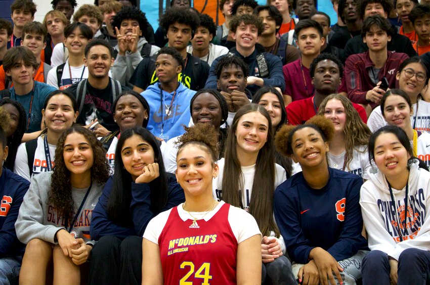 Justice Carlton poses for a photo with her Seven Lakes teammates and classmates during Wednesday&rsquo;s McDonalds All-American jersey dedication ceremony at the Seven Lakes gym.