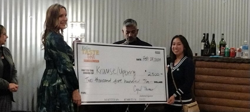 Katy Taste Fest organizer Cyril Thomas (center) awards a check for $2500.00 to Upbring/Krause, one of the eight local charities to benefit from the proceeds from the 2023 festival. The monetary awards were made on February 28th at Typhoon Texas, where the 2024 festival was held on March 2.