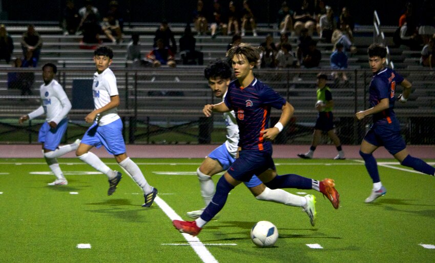 Kortay Koc dribbles up the field during Friday&rsquo;s game between Seven Lakes and Paetow at the Seven Lakes soccer field.