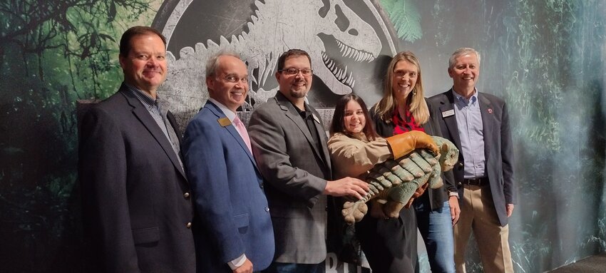 Attending the ribbon cutting for Jurassic World: The Exhibition and meeting Baby Bumpy were City of Katy City Administrator Byron Hebert, State Representative Michael Schofield, Katy Mayor Pro Tem Chris Harris, Baby Bumby&rsquo;s handler Jordyn Chuter of the Jurassic World staff, City of Katy Councilmember Gina Hicks, and Katy Mayor Dusty Thiele. The exhibition is open through October 26th at Katy Mills Mall.