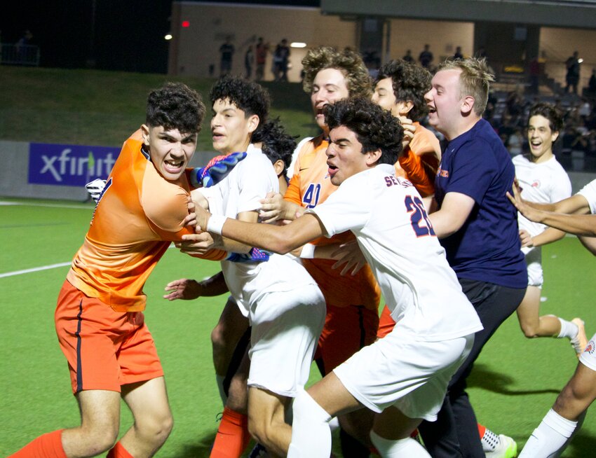 Ben Aviles Vera celebrates with teammates after scoring the game winning penalty in Monday's Region III-6A Quarterfinal between Seven Lakes and Jordan.