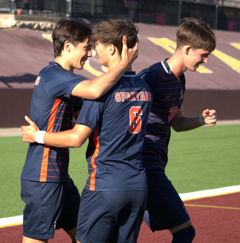 Noa Stasic celebrates with Kortay Koc and Aiden Morrison after scoring a goal during Friday's Region III-6A Semifinal between Seven Lakes and Humble in Deer Park.