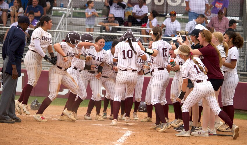 Cinco Ranch&rsquo;s softball team celebrates after Lindsey DeLeon hit a grand slam during Saturday&rsquo;s bi-district game between Cinco Ranch and George Ranch at the Cinco Ranch softball field.