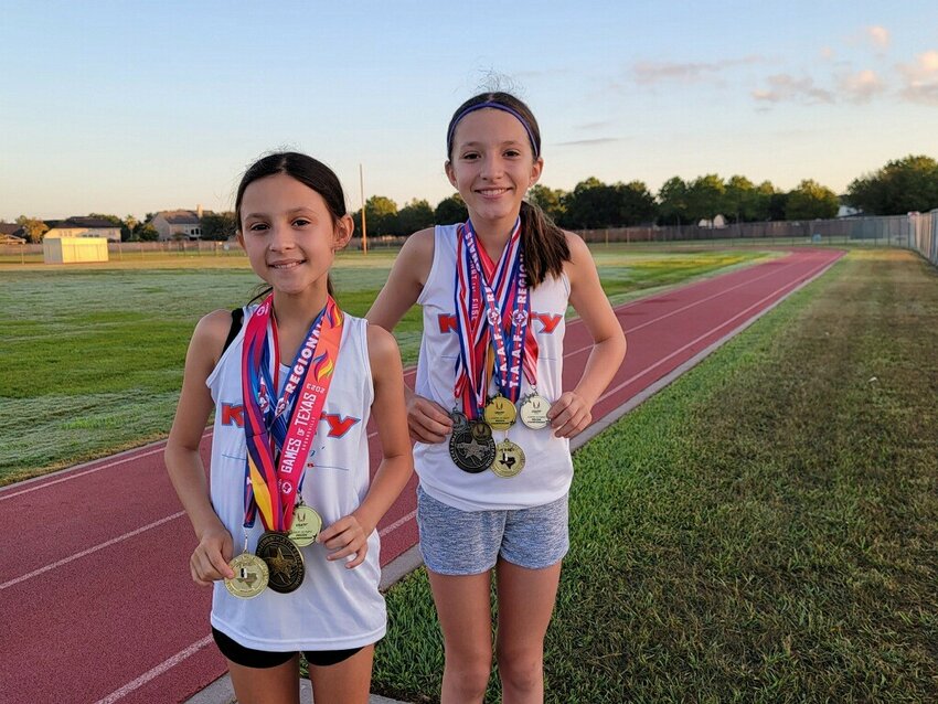Caroline and Corinne Reina with their medals from a meet last year.