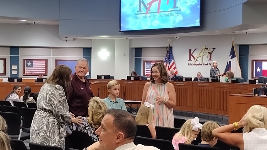 Don Clayton (second from left) visits with friends and family prior to the start of Monday night&rsquo;s school board meeting at the Education Support Complex at 6301 S. Stadium Lane in Katy, where trustees voted to approve the naming of the field house at Cinco Ranch High School, 23440 Cinco Ranch Blvd. in Katy, for Clayton, the school&rsquo;s former athletic director. Clayton said he spent 31 of his 38 years in education in Katy ISD.