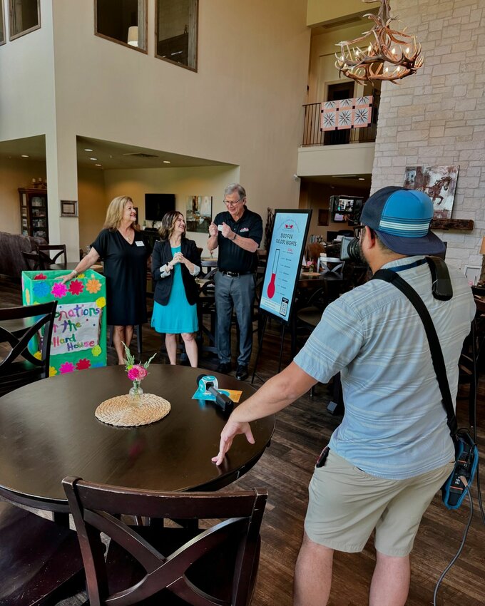 Ballard House Naomi Williams, Community Outreach Coordinator (left) and Executive Director David Brown (center) visit with Houston Life host Lauren Kelly (second from left) as they prepare to film a segment for the TV show on July 17 at The Ballard House, 21421 Cinco Park Rd. in Katy.