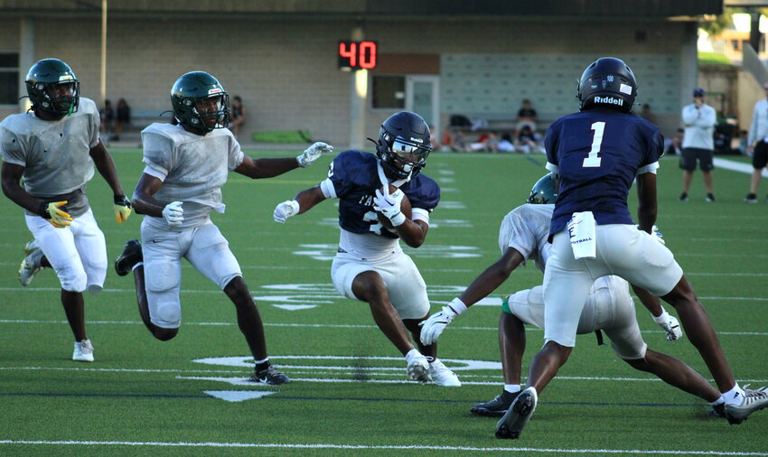 Robert Bernard cuts upfield during Thursday&rsquo;s scrimmage between Tompkins and Klein Forest.