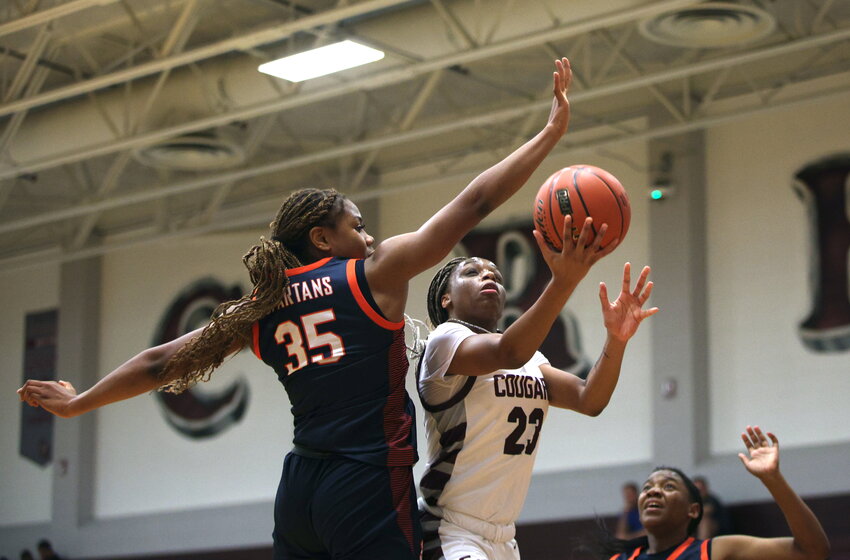 Aniya Foy tries to shoot over a defender during Tuesday&rsquo;s District 19-6A game between Cinco Ranch and Seven Lakes at Cinco Ranch High School.