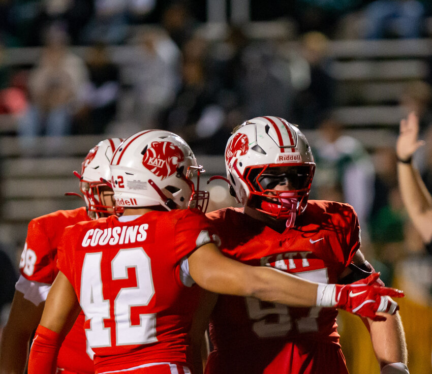 Adam Carter and teammates celebrate after a Carter sack during Friday&rsquo;s area round game between Katy and Cy-Falls at Tully Stadium.