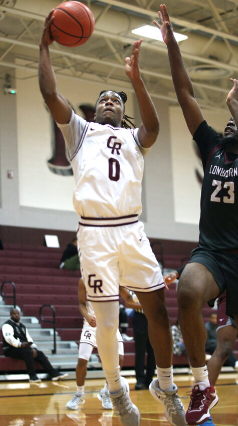 Prince Jones-Bynum shoots a layup during a game between Cinco Ranch and George Ranch at the Cinco Ranch gym.