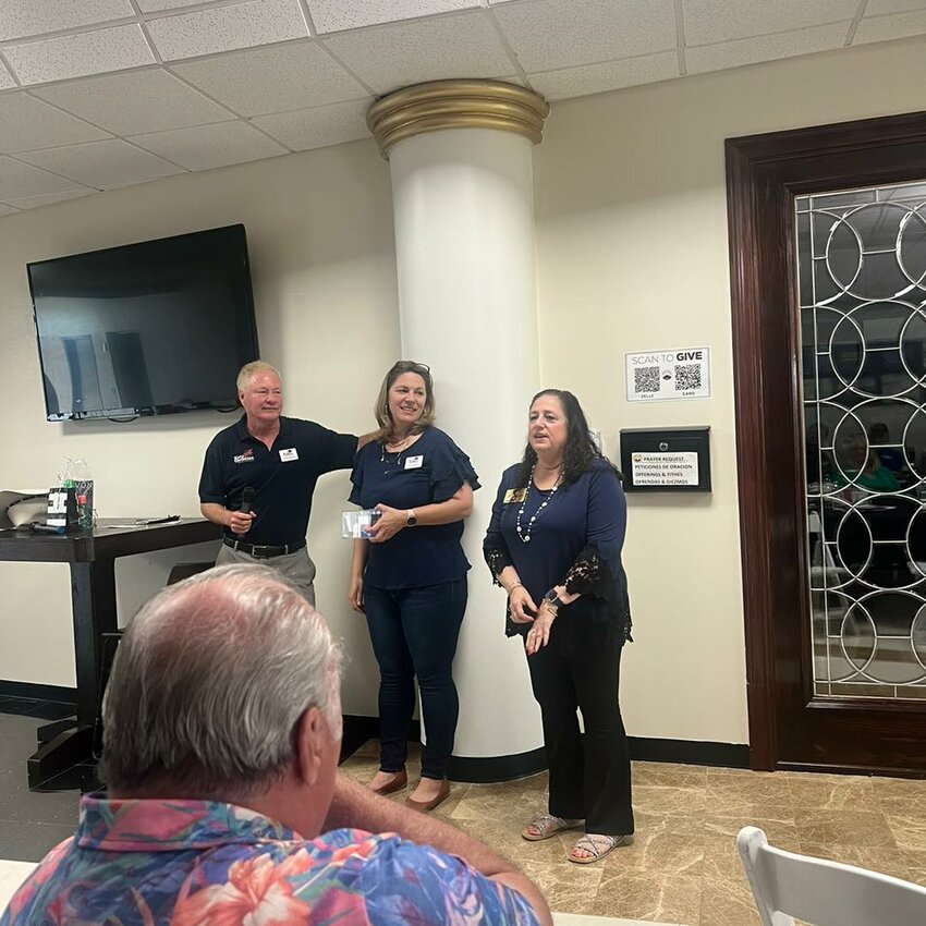 Joe Menslage (left) and Erica Scardino (center), executive directors of the Katy Christian Chamber of Commerce, listen as member Karen Kurt addresses attendees at the August 16, 2024, meeting of the organization at the Church on the Rock, 433 Barker Cypress Road in Houston. The chamber celebrates its fifth birthday in February.