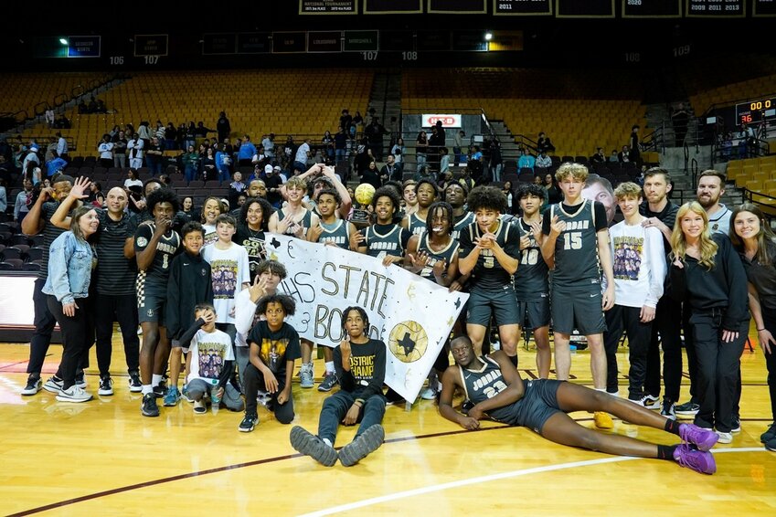 The Katy Jordan Warriors celebrate with the game trophy after beating San Antonio Harlan in the state semifinal game on March 4, 2025, in San Marcos, Texas.