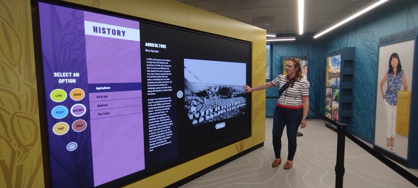 Becky McGrew, city secretary for the City of Katy, demonstrates the interactive screen at the new visitor&rsquo;s center. Patrons can select specific options in order to learn more about where to live, work, play and more by touching a button.