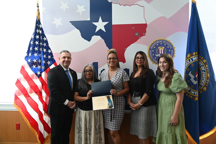 FBI Houston Special Agent in Charge Douglas Williams (left) presents the 2024 FBI Director&rsquo;s Community Leadership Award to representatives of Katy Christian Ministries on May 9, including (left to right) Domestic Violence Advocate Yolanda Armenta, KCM Crisis Center Director Makia Walls, KCM CEO Virginia Gonzalez and Sexual Assault Advocate Abbie Richards.