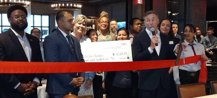 Following a proclamation by James Burnett, Harris County Precinct 4 Community Engagement Coordinator (left), General Manager Luis Carmona looks on as Barry McGowan, Chief Executive Officer of Fogo de Ch&atilde;o (far right, with microphone) presents a check for $20,800.00 to Gloria Castillo and Jeanette Trejo of Katy Christian Ministries. Adrienne Davitz of the Katy Area Chamber of Commerce (far right, behind McGowan) welcomed the Brazilian steakhouse at 222 West Grand Parkway South in Katy to the area during the May 8 ribbon cutting at the restaurant.