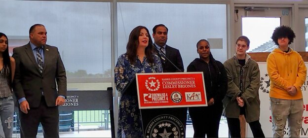 KISD Superintendent Ken Gregorski (left) listens as Harris County Precinct 4 Commissioner Lesley Briones (center), accompanied by Executive Director of the Office of the County Engineer for Harris County Milton Rahman, gives an overview of the &ldquo;Sidewalks 4 Precinct 4&rdquo; project at a ribbon cutting ceremony  at the field house at Legacy Stadium, 1830 Katyland Drive in Katy, on May 6. Also pictured are students from Miller Career Center, who also spoke in support of the project.