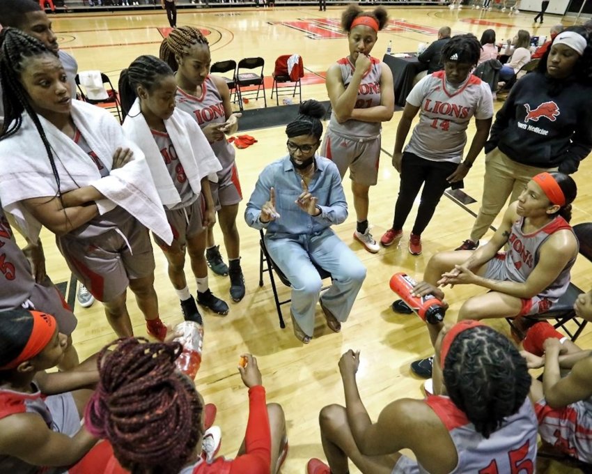 Coach Sharon Thompson&rsquo;s East Mississippi Lady Lions listen up during a timeout in an earlier game. In the other photo, Ja&rsquo;Mia Hollings takes a shot in an earlier game. The Lady Lions were 12-4 when they played Coahoma in the semifinals Wednesday at Mississippi College.