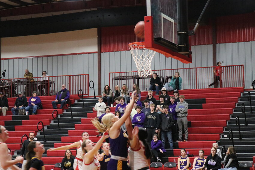 Senior Cadence Chaffin shoots the ball as Stoutland supporters look on.