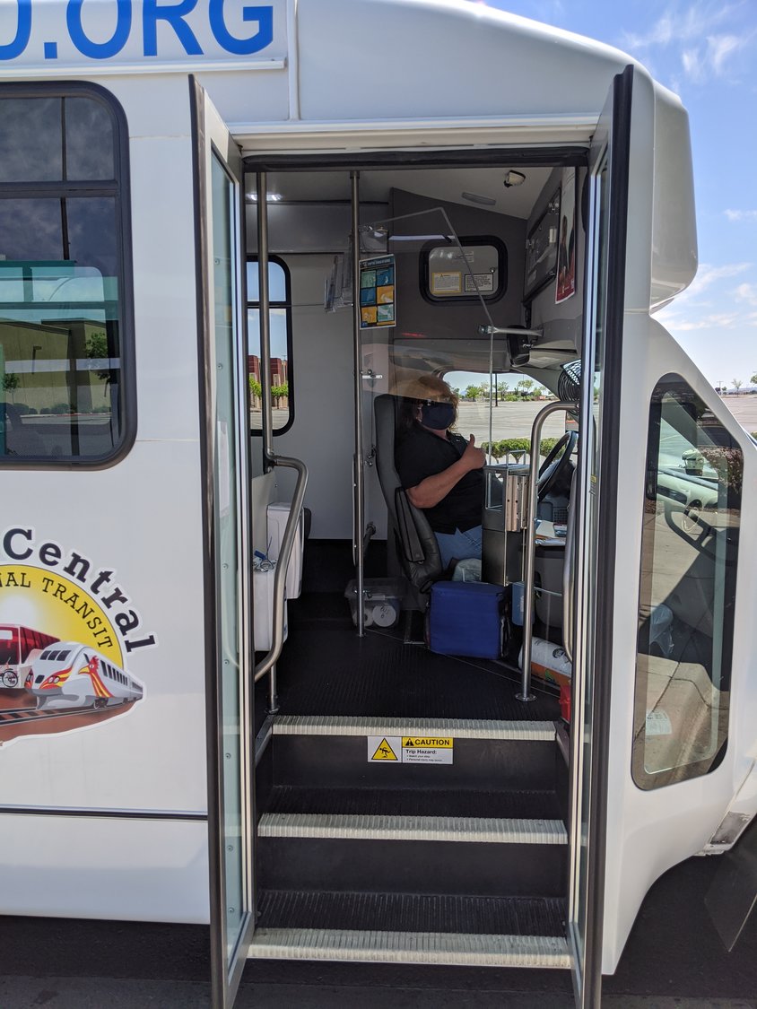 A masked South Central Regional Transit District driver sits behind a newly installed plexiglass shield designed to help prevent transmission of the COVID-19 virus