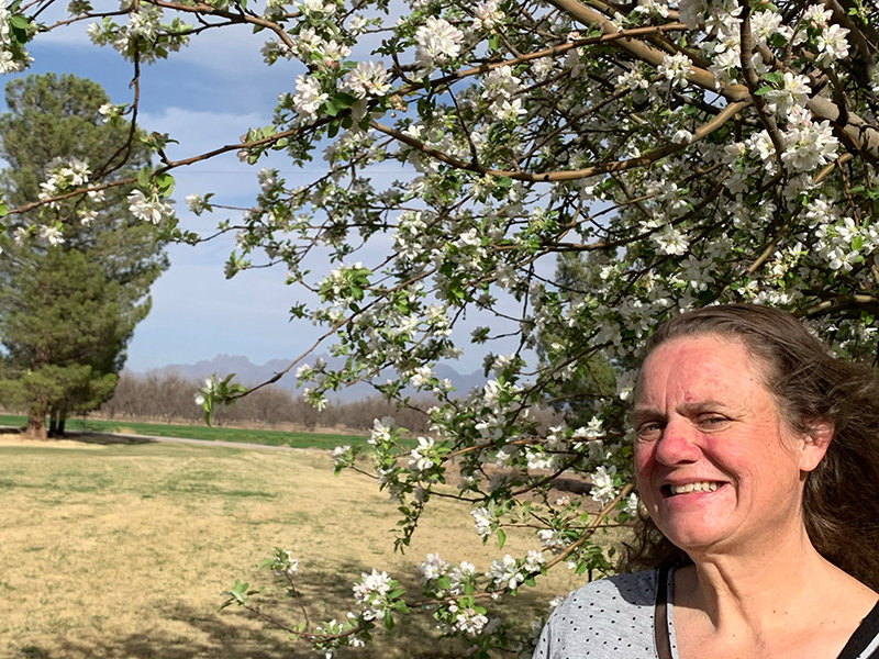 LuAnne Burke works in her beloved apple orchard in the Rio Grande Valley just north of Las Cruces.