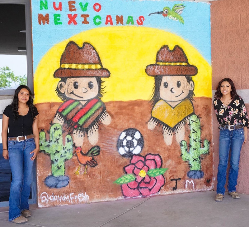“Nueva Mexicanas” is a mural painted by Yanelly Garcia, Mariana Cordova and Jennifer Cordova. The two artists shown in the photo are Jennifer Cordova, left, and Mariana Cordova. Not shown is Yanelly Garcia.
