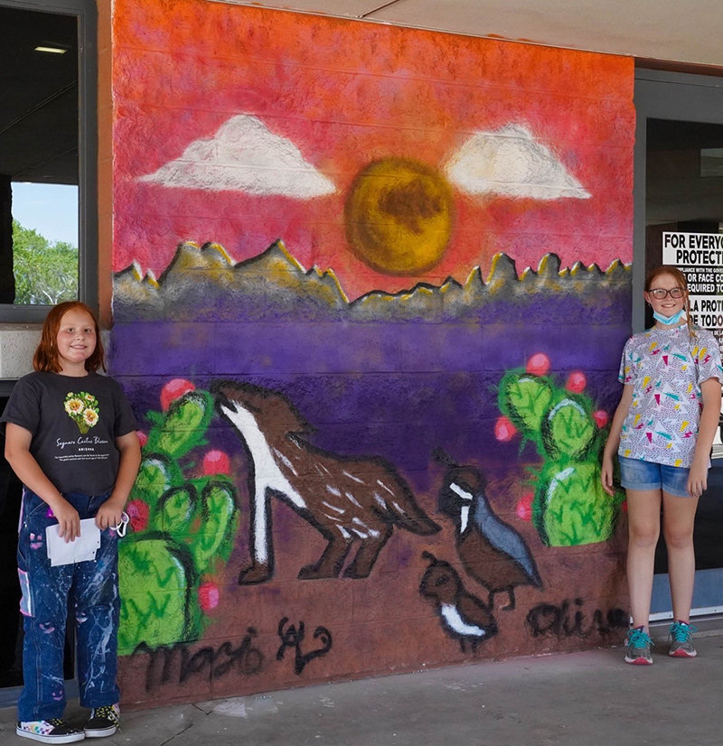 “Full Moon Over the Organ Mountains” is the mural painted by sisters Olive Japel, left, and Mazie Japel.
