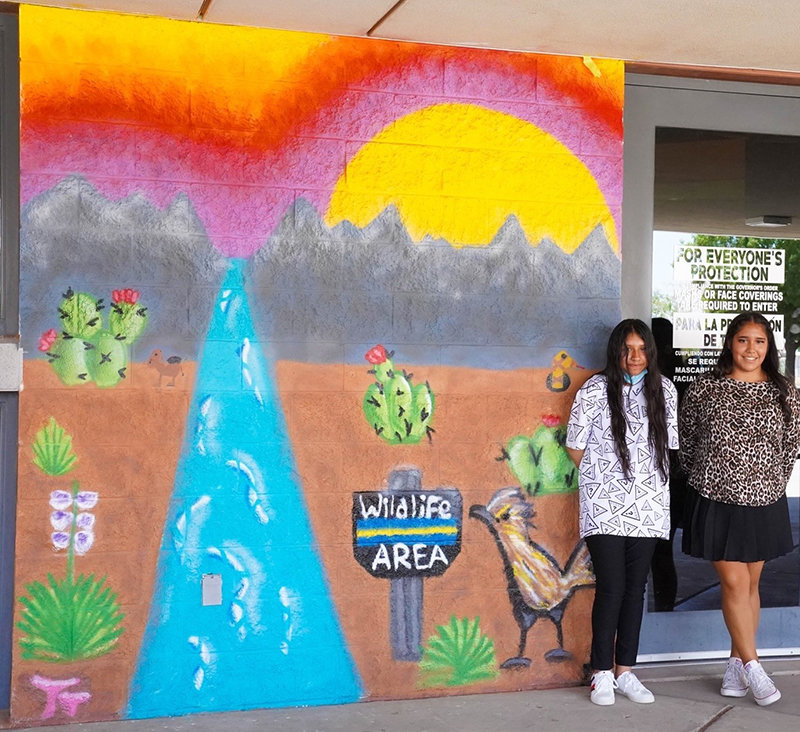 Organ Mountain High School muralists Tahlor Triolo, left, and Sarahi Alvarado, painted “Preserve Wildlife.”
