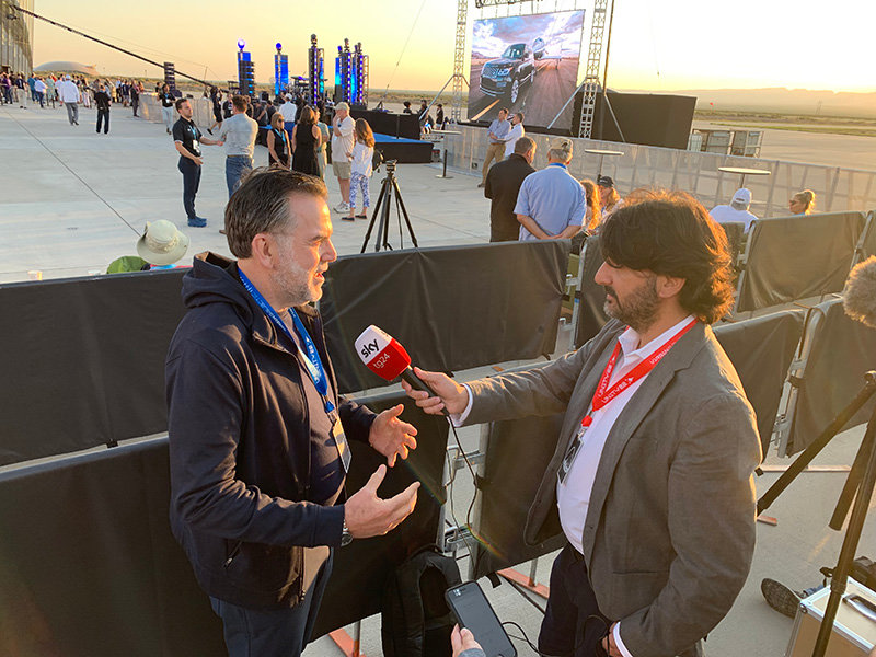 Previous New Mexico Economic Development Secretary Rick Homans speaks with Italian SKY TV network reporter Fabio Russomando. The Virgin Galactic/Spaceport America event drew members of the press from many corners of the earth.