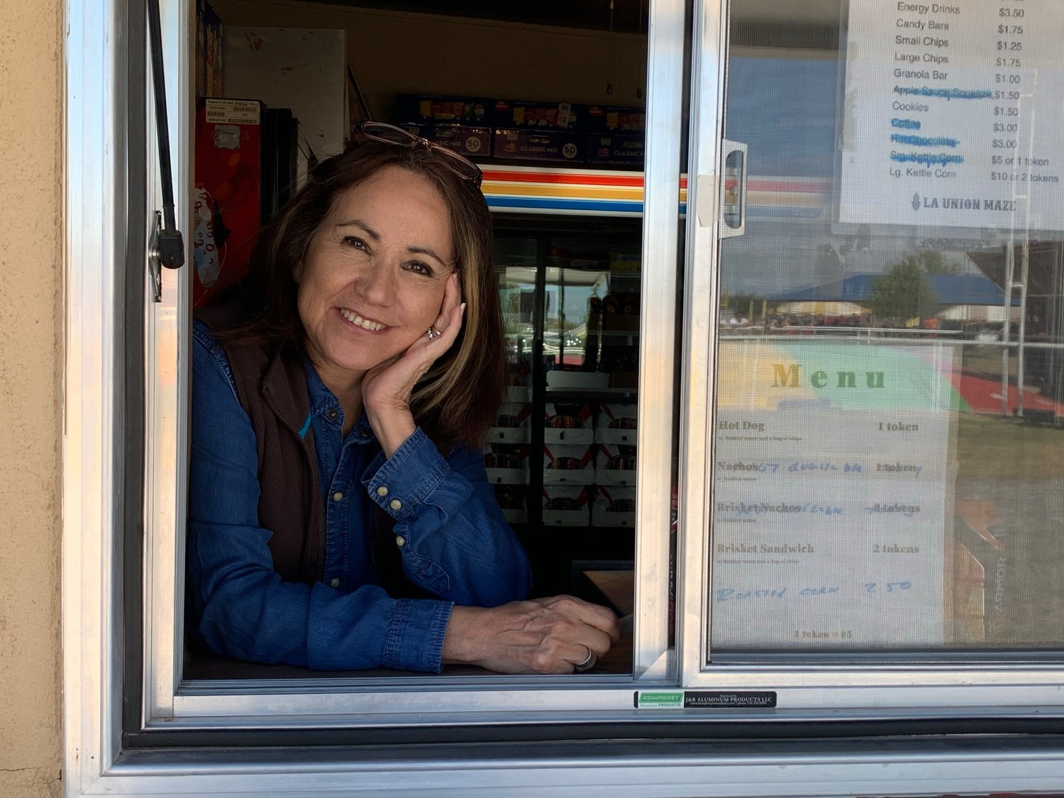 La Union Maze owner Lucy Sondgeroth mans the concessions booth Wednesday, Oct. 13. Among the treats available at the site are fresh corn on the cob and brisket sandwiches.