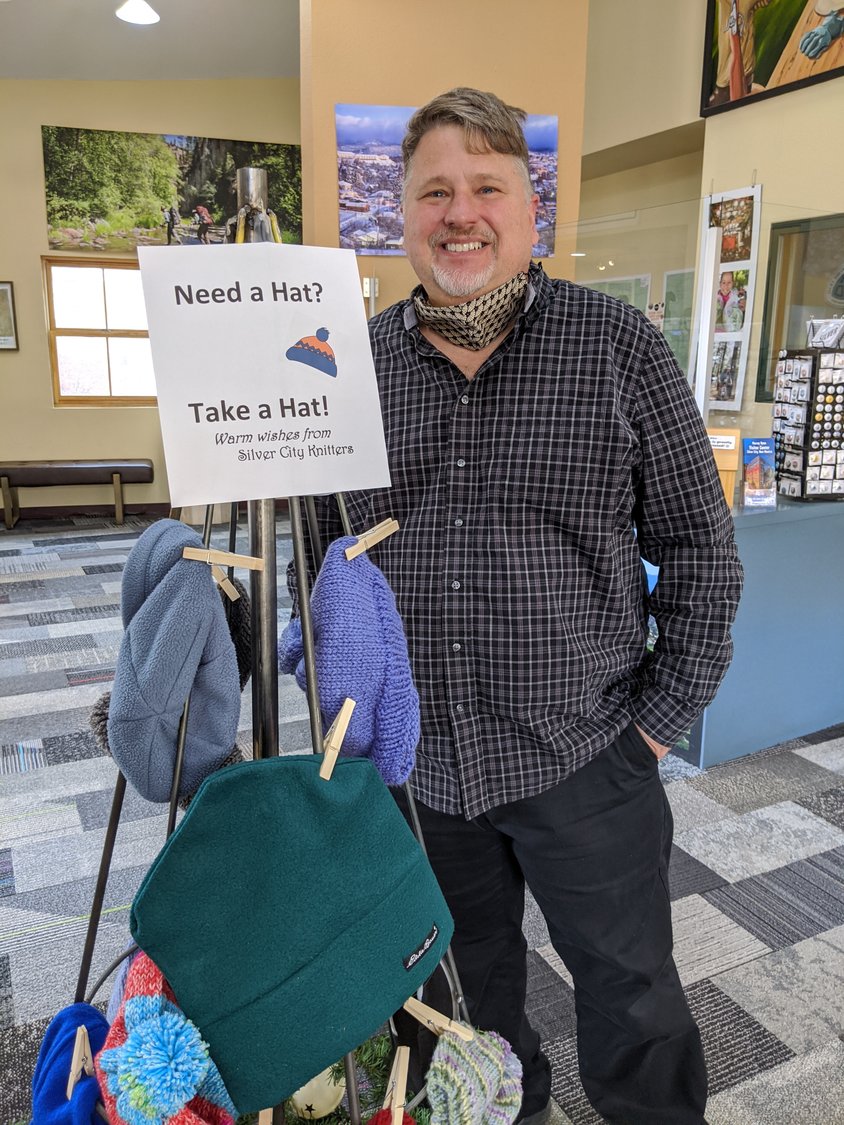 David Chapman, manager of the Visitor Center and the Need a Hat, Take a Hat 2021 hat tree.