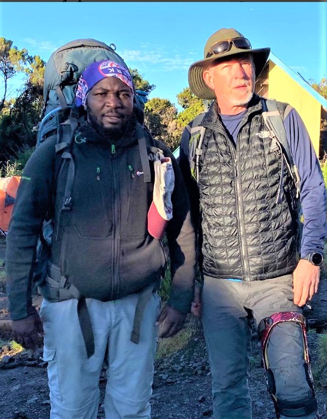David Hill and his Mount Kilimanjaro guide, Salim, a native Tanzanian who has been a professional mountain-climbing guide for 17 years and has climbed Mount Kilimanjaro about 250 times.