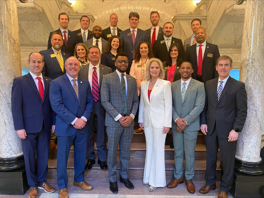 Pictured, front row from left, are Rep. Clay Mansell, Rep. Jonathan McMillan, Senator Walter Michel, Rep. Lawrence Blackmon, Rep. Jill Ford, Senator Bradford Blackmon, Senator Briggs Hopson. (Second row) Brent Bailey, Efficient Power & Light; Bethany Stanfill, BSS Global; Katie Hutson, Harper Rains Knight Company; Kristen Ellis, C Spire; Amanda Wyrick, Community Bank; Calvin Hill, Nissan North America. (Third row) Wesley Self, Wages Civil LLC; Sammy Brown, Brown Legal Group; Brad Gatlin, BankPlus; Nick Newcomb, StorageMax; Nathan Witt, Ergon. (Back) Kendall Gregory, CRH; Camp Murphy, Capitol Resources LLC; Jarrett Taylor, Neel Schaffer.