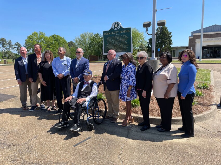 Rosa Scott’s first principal H.T. Drake, center, is flanked by current and former administrators, principals and assistant principals at a dedication ceremony of a new historical marker on the school grounds Wednesday. Pictured, from left with Drake are Dr. Ronnie McGehee, Brent Cofield, Devona Dew, Carl Lucas, Mike Kent, Ted Poore, Charlotte Seals, Sue Jones, Dr. Fannie Green, and Dr. Kim Brewer.