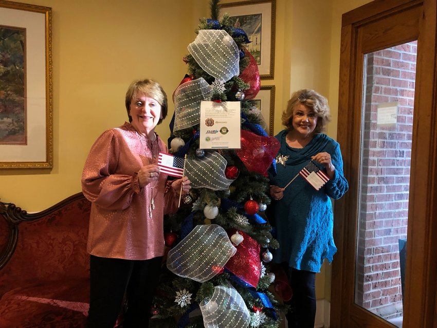 Madison Alderman Janie Jarvis and Mayor Mary Hawkins-Butler stand in front of the Hero Tree at City Hall, one of the three locations for the Hero Tree project in Madison County. The Hero Tree was inspired by the Angel Tree Project put on by the Salvation Army each year, and it helps out homeless veterans in need by providing them with personal care items.