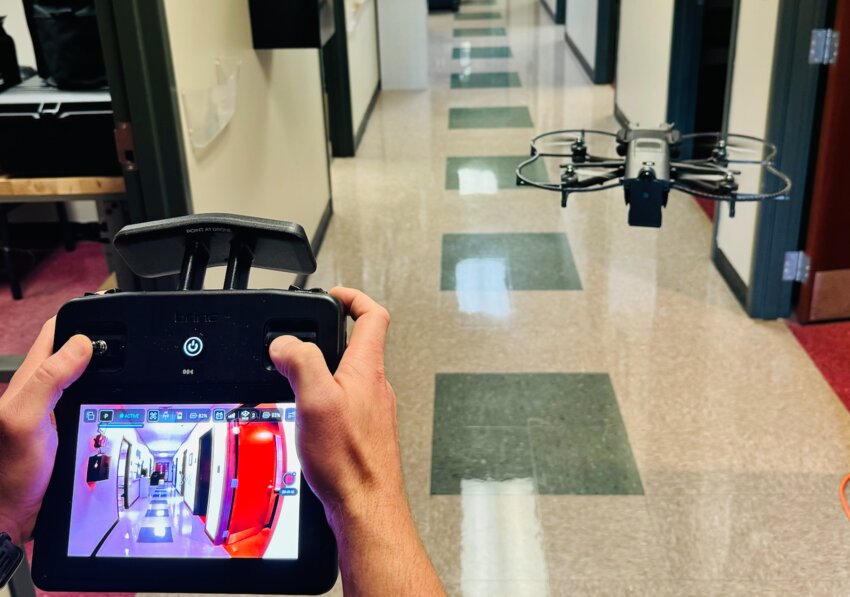 One of the department’s drone operators, Investigator Bryce McCarra, demonstrates the use of the indoor drone at police headquarters.