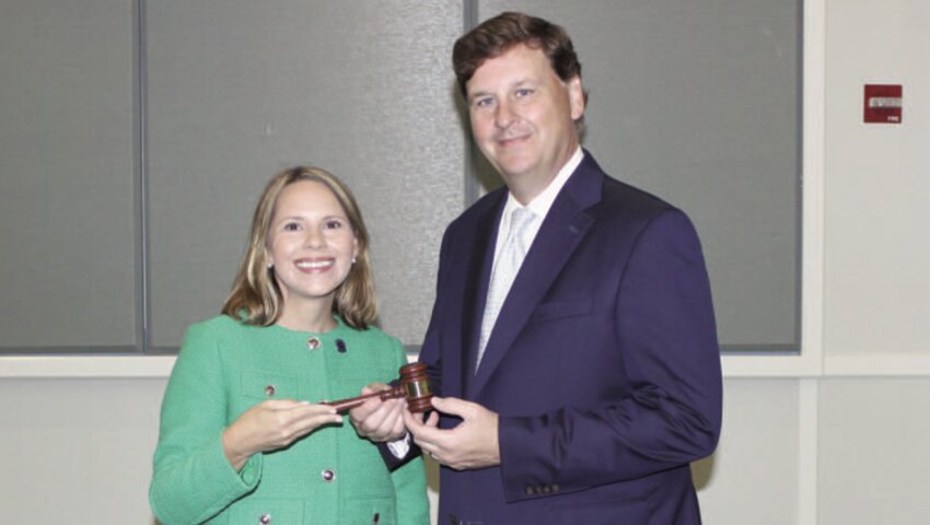 Outgoing Mississippi Bar President Jenny Tyler Baker of Biloxi passes the gavel to Meade W. Mitchell.