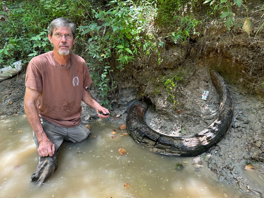 Eddie Templeton poses with the seven foot mammoth tusk he found in a Madison County creek on Aug. 3 that’s 12,000 years old.