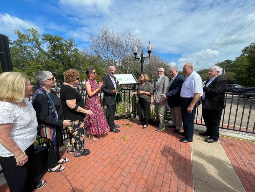 Ridgeland Mayor Gene McGee, center, cuts a ceremonial vine to commemorate the city’s new History Trail on Tuesday. McGee was surrounded by aldermen, city officials and members of the Historical Society of Ridgeland.