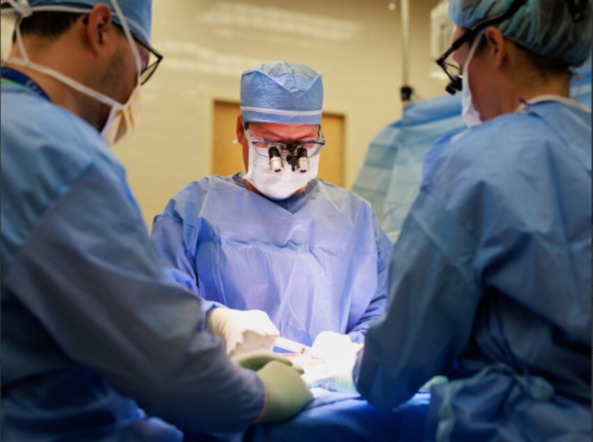 Dr. Marc Walker, director of The Jabaley-Songcharoen Center for Hand, Upper Extremity and Nerve Surgery, and surgical team operate on Trey Wheeler of Brandon.