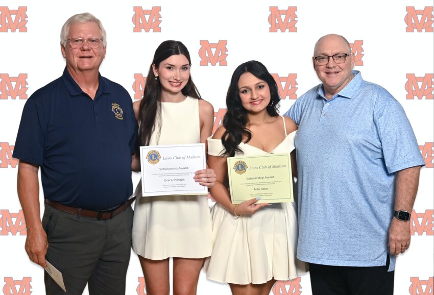 Madison Lions Club President Wesley Edwards (left) along with Lions Club member and MCHS faculty member Ken Hackman (right) presented Gracie Pringle and Nilu Attar with a scholarship. These students participated and planned community service as active members in their community.