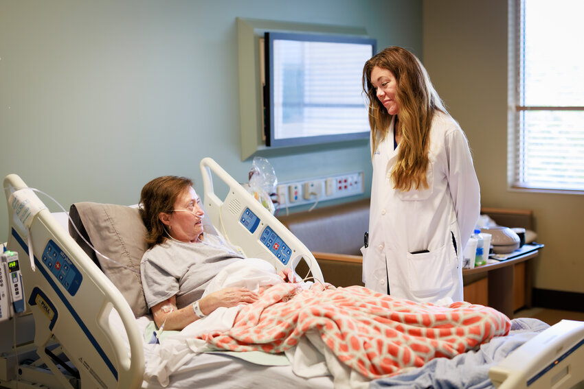 Dr. Laura Fincher, hospitalist and assistant professor of medicine, meets with patient Lerita Stacy of Camden.