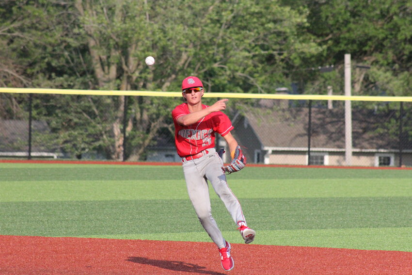 Mexico sophomore Austin Maxwell throws to first base for an out from behind second base against Macon on Thursday in the Class 4 District 7 title game in Macon.