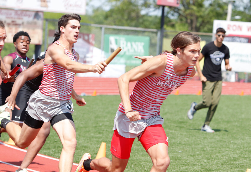 Mexico senior Morgan Grubb hands the baton to sophomore Tyler Grimes in the 4x100-meter relay on Saturday in the Class 4 Sectional 2 meet at Ron Whittaker Track in Mexico. The Bulldogs qualified for the Class 4 state meet this Friday and Saturday at Adkins Stadium in Jefferson City in the event while setting a school record, Grubb also qualified also in the pole vault, and Grimes qualified in the 800-meter run and 4x400-meter relay.