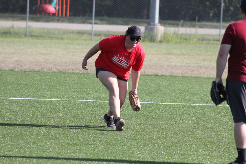 New Mexico softball head coach Hanna Branch fields a ground ball on Friday during the Lady Bulldogs' final summer practice. Branch showed how to do the drill before letting her players try.