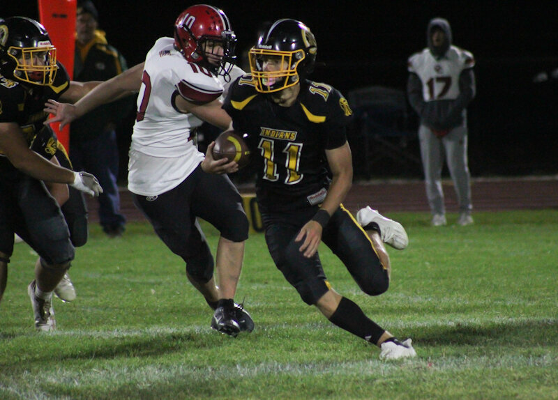 Van-Far senior quarterback Nikos Connaway runs with the ball before breaking off for a 54-yard touchdown run against Crystal City on Friday in Vandalia.