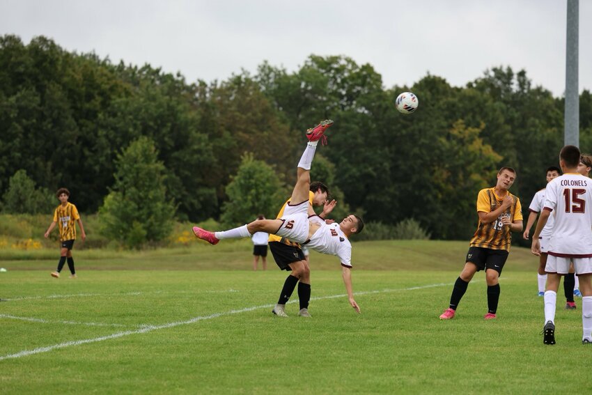 Missouri Military Academy junior Fernando Puebla goes airborne for a kick on Friday at Fulton.