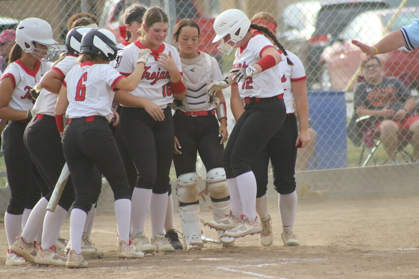 Community R-6 freshman Myla Carroll jumps on to home plate after hitting her first career varsity home run and the team's first home run this season on Wednesday against Paris at home in Laddonia.